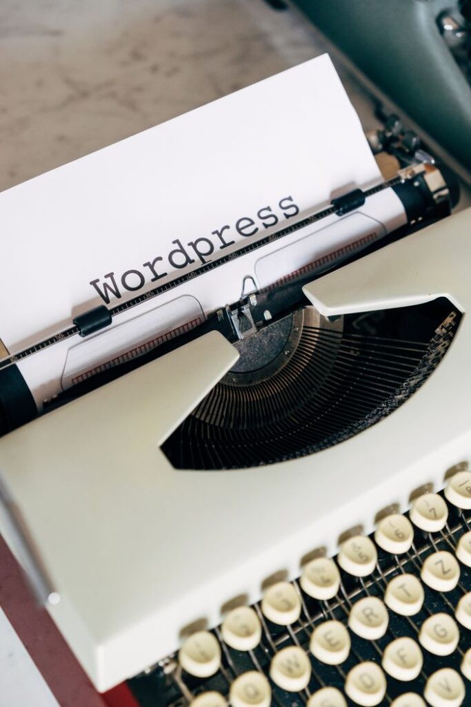 The Art of Drawing Readers In: Your attractive post title goes here Close-up of a vintage typewriter with 'Wordpress' typed on paper, conveying a classic theme.