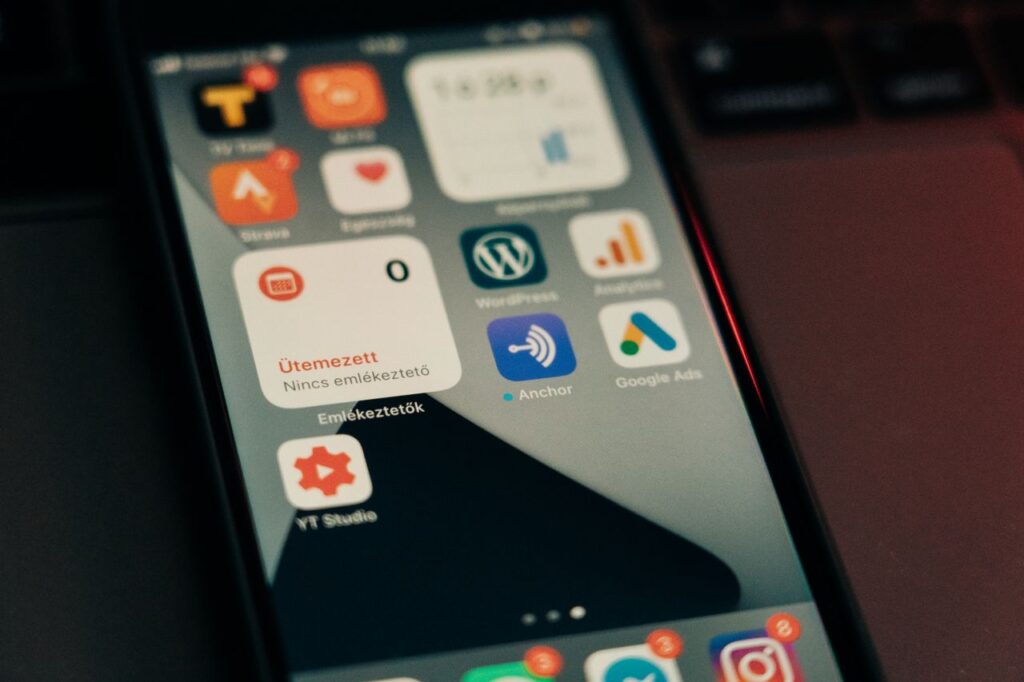 Crafting Captivating Headlines: Your awesome post title goes here Close-up view of smartphone screen featuring various app icons and notifications.